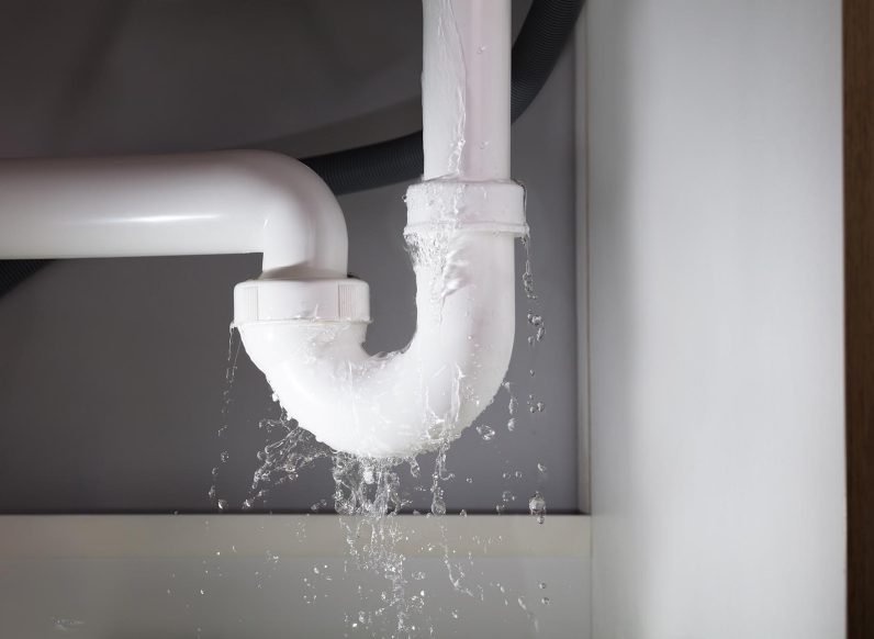 Close-up,Of,Water,Is,Leaking,From,The,White,Sink,Pipe