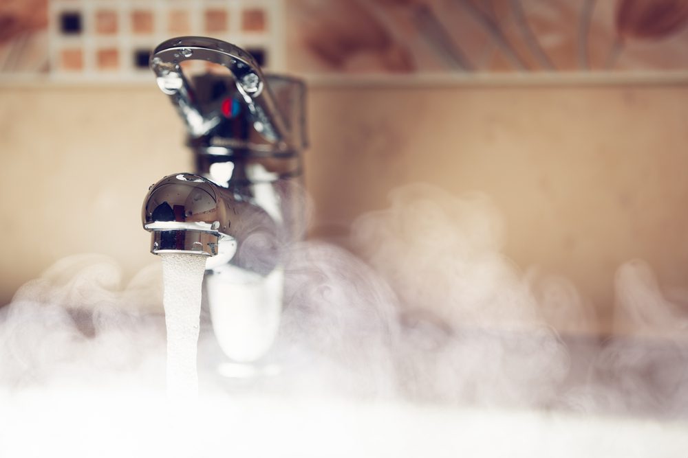 Hot water coming out of a tap, causing steam