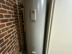 New electric hot water system beside a brick wall in Bangor