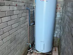 New electric hot water system against a brick wall in Bangor