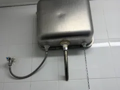 Stainless urinal cistern after a new inlet valve, outlet valve and pull chain were fitted in Caringbah