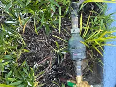 New pressure reduction valve on a water meter in a garden in Engadine