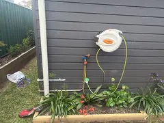 New hose reel and garden tap on the side wall of a Gymea home