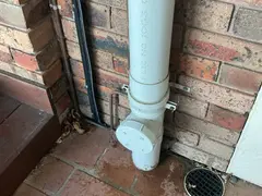 Sewer inspection opening beside a downpipe at an Illawong home