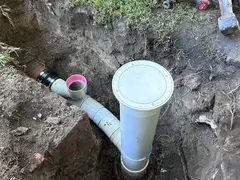 New PVC sewer junction and riser at an excavated shaft in a Jannali backyard