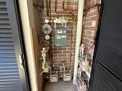 Gas meters and valves in the services cupboard of a Kirrawee unit complex