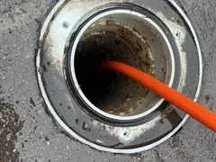 Jetter hose in a sewer opening at a Loftus home