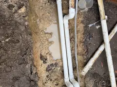 New pool heating pipework run deeper in a Menai garden