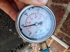 Pressure gauge on a hose tap after a pressure reduction valve was fitted in Miranda