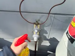 Leak test spray on an LPG regulator at an Oyster Bay home