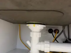 New trap and double bowl connector under a kitchen sink in Sutherland