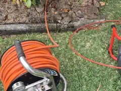 Drain camera reel on a lawn during a sewer inspection in Sutherland