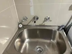 New wall-top taps over a stainless laundry tub in Sylvania