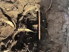 Damaged copper water pipe in a garden trench in Sylvania Waters